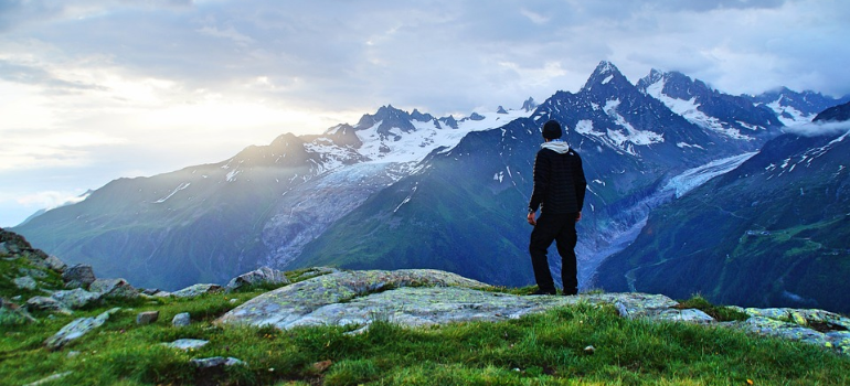 A hiker enjoying the view from the top of a mountain.