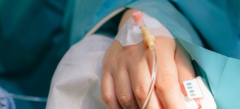 A patient in intensive care receiving IV, representing the difference between opiates and opioids