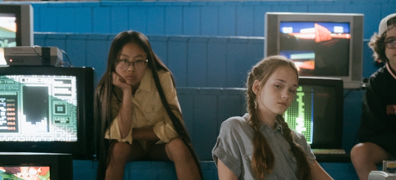 three adolescents in an IT lab