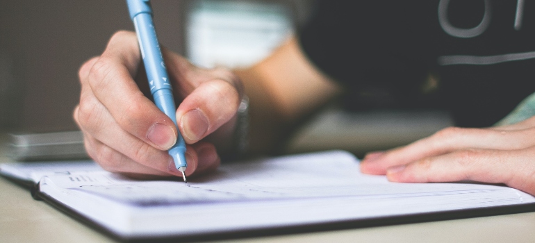 person writing about Hobbies To Help You Stay Sober After Rehab in West Virginia