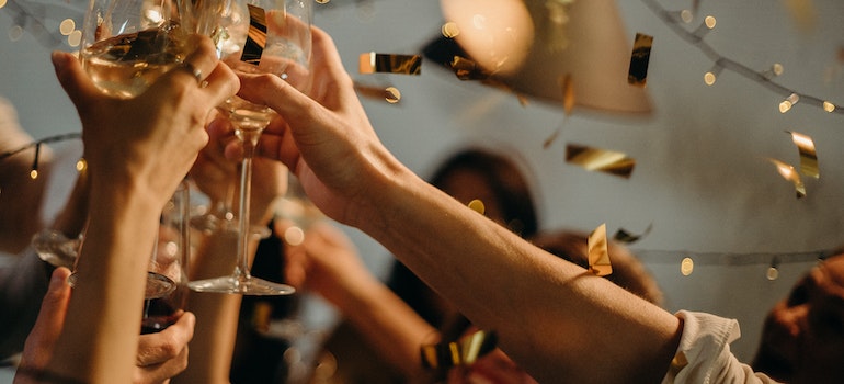 People clinking their glasses at a party without recognizing and managing triggers
