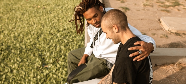 two friends talking on the bench as a way to Support a Friend in Recovery