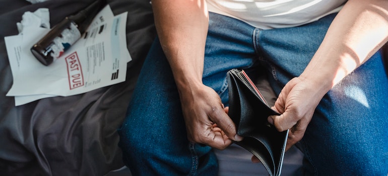 A person looking at an empty wallet