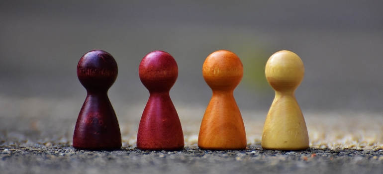 wooden pawns in different colors