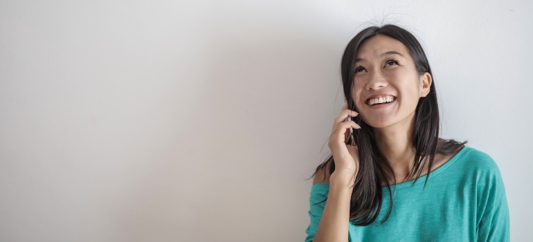 happy woman talking to someone on a phone