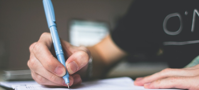 unrecognizable guy writing a plan for traveling while in recovery