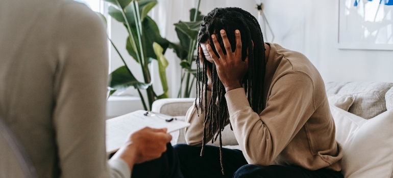 a young man at a therapy session learning how to practice self-compassion during addiction recovery