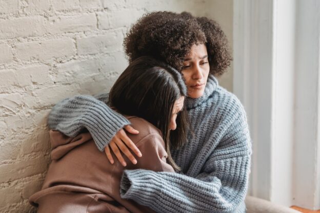 woman comforting her friend