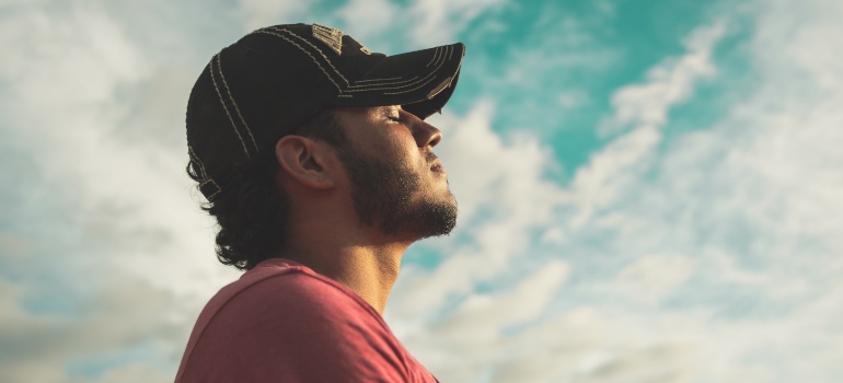 calm man who has learned how to cope with anger in addiction recovery outdoors