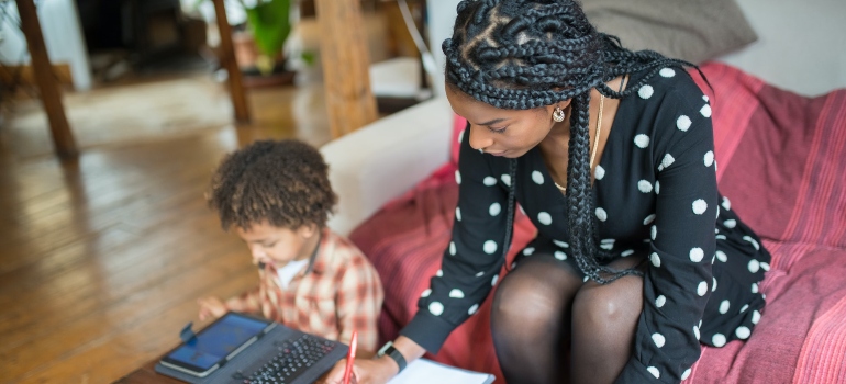 focused braided woman writing tips for moms in recovery