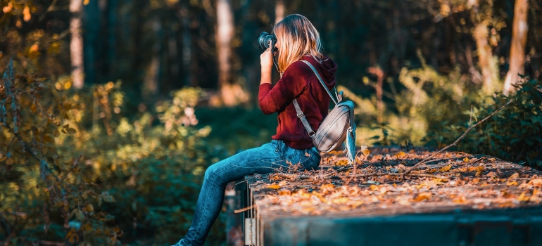 focused photographer taking a photo in nature