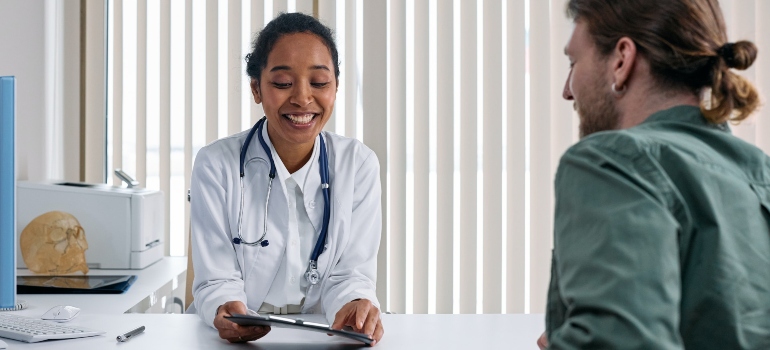 young doctor explaining the benefits of Psychotherapy in addiction treatment