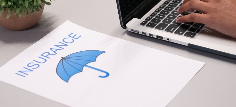 the word insurance and a blue umbrella on a piece of paper