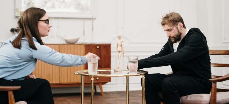 a young man during a therapy session learning how to cope with anger in addiction recovery