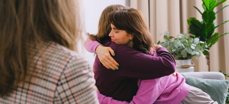 woman giving hug to a loved one