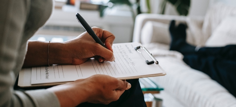 unrecognizable person writing notes