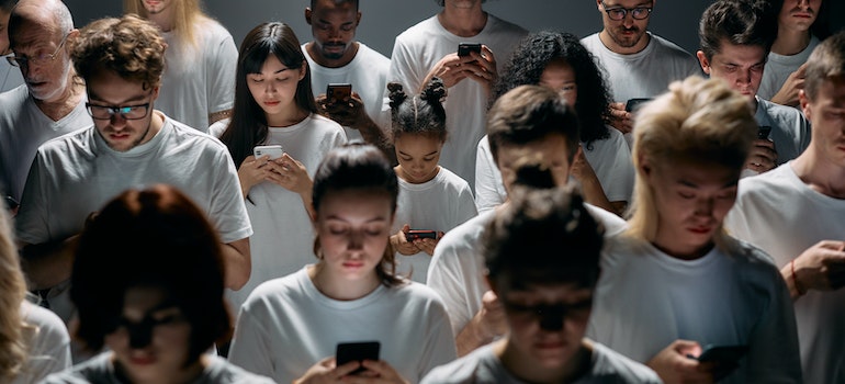 Group of people all looking into their phones.