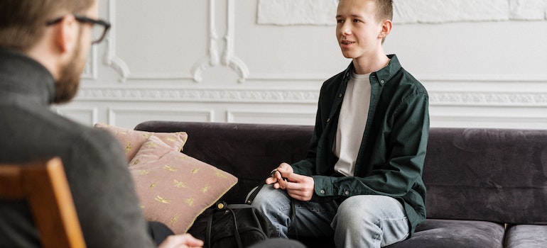 A young person in therapy discussing mental health and addiction issues in LGBTQ+ community