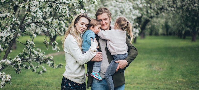 a happy family hugging in the park