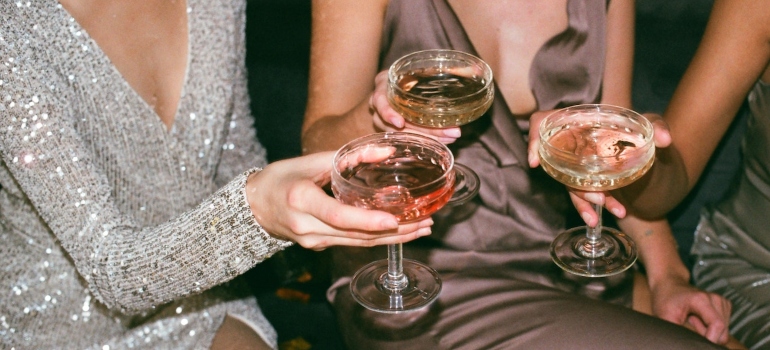 Three women sitting next to each other and celebrating