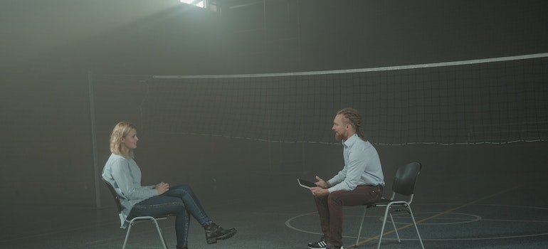 A therapist and a patient talking in a space for group therapy