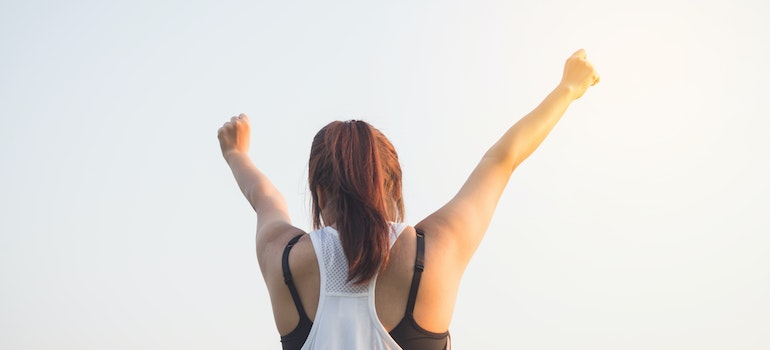 motivated person with her hands in above her head