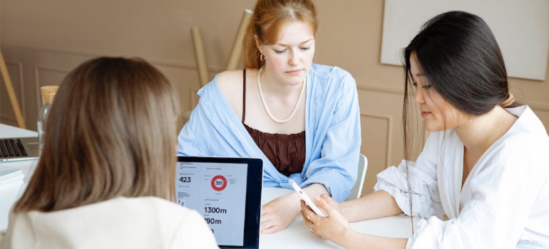 Medical staff in scrub suits reviewing data in an office.
