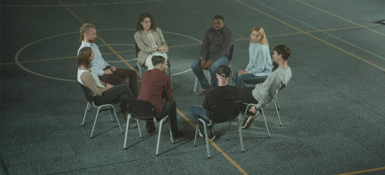 A group of people during a therapy session indoors.