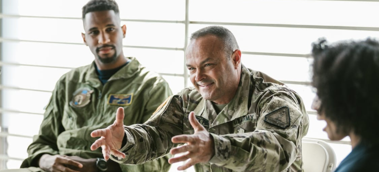 Men in uniform during a group therapy session indoors.