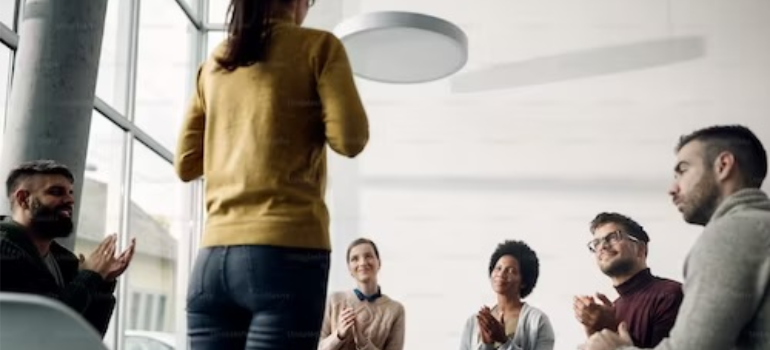 A group of people during a psychotherapy session, illustrating the use of support groups in addiction treatment.
