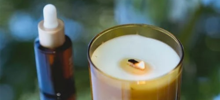 A natural oil and a scented candle, symbolizing alternative therapies for addiction within a holistic approach to recovery.