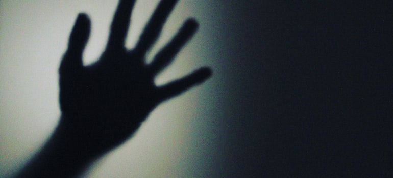 A shadow of a hand in the dark