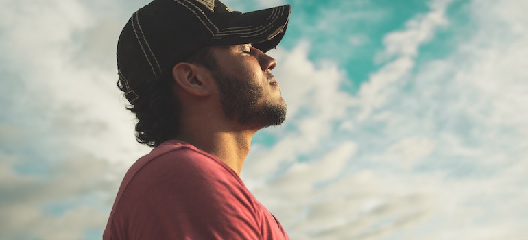 Man holding his eyes closed showing how spirituality supports lasting recovery