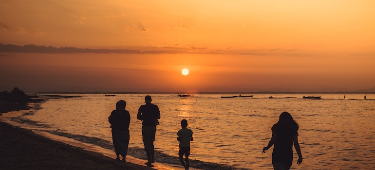 Family walking on a beach at sunset representing what to do if Drug or Alcohol Abuse Runs in Your Family
