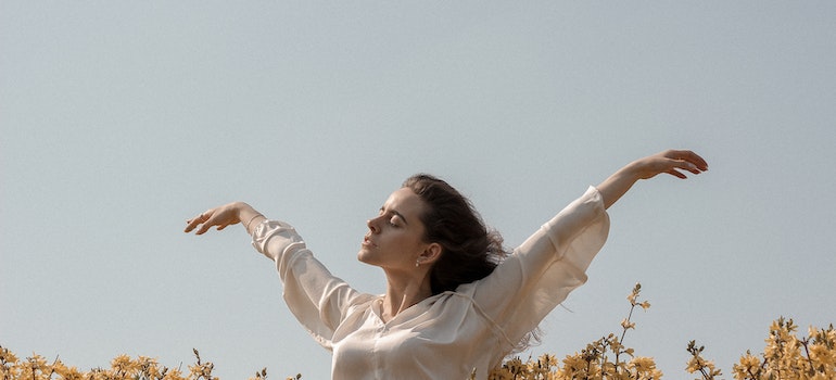 A calm and happy woman with her hands in the air