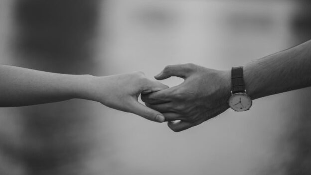 Couple holding hands.