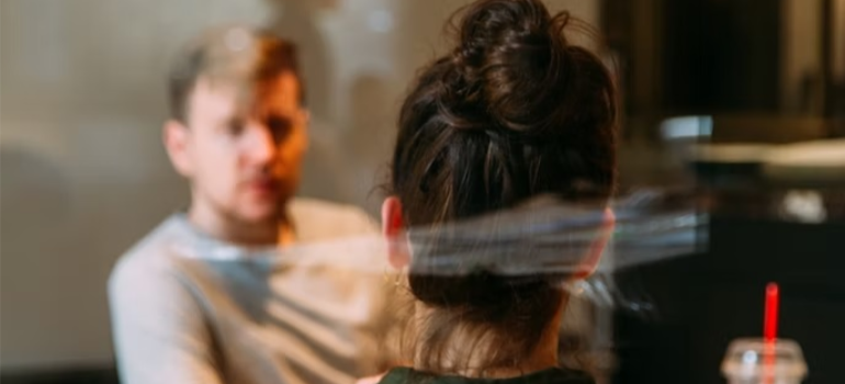 A close-up of a couple discussing early intervention in addiction treatment.
