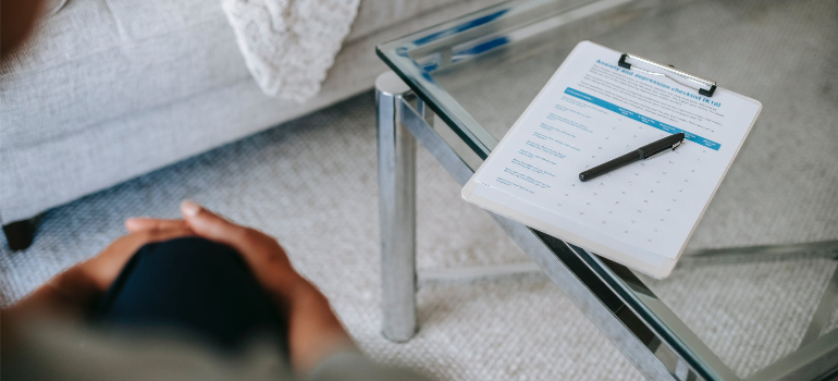 A close-up of a therapist keeping notes on heroin addiction health risks during a psychotherapy session.