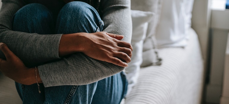 woman embracing her knees