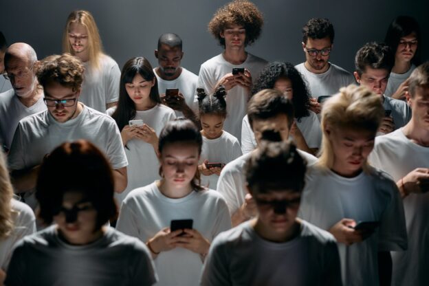 a group of people looking at their phones
