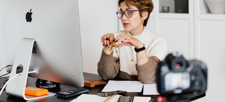 a woman sitting by her laptop representing telehealth as a way to address the challenges to accessing substance abuse treatment in West Virginia