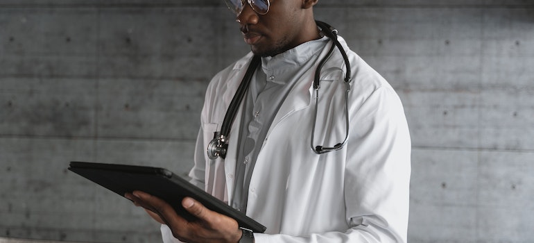 a doctor using a tablet representing challenges to accessing substance abuse treatment in West Virginia