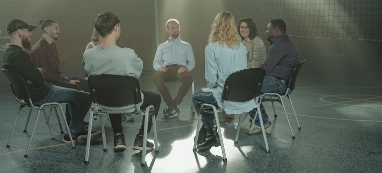 Group of people discussing why harm reduction is crucial in substance abuse treatment
