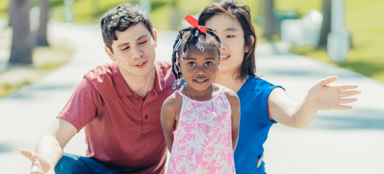 a happy couple with their adopted kid experiencing the The Impact of Addiction on the Local Foster Care System in Parkersburg WV