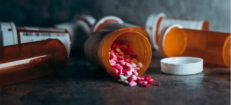 A drug bottle on its side, symbolizing the harmful long-term effects of benzodiazepine addiction.