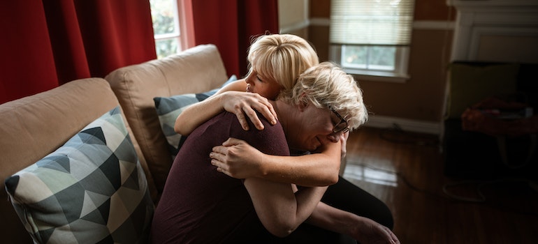 Persons hugging to show support