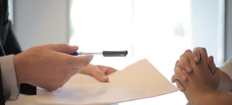 Person being handed a document to sign