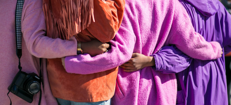 Four women hugging each other.