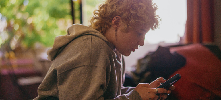 A person looking up medications used in addiction treatment in West Virginia on their phone.