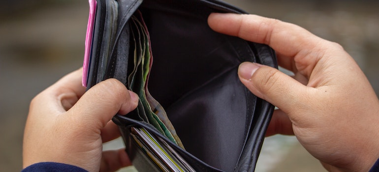a man looking at the mostly empty wallet